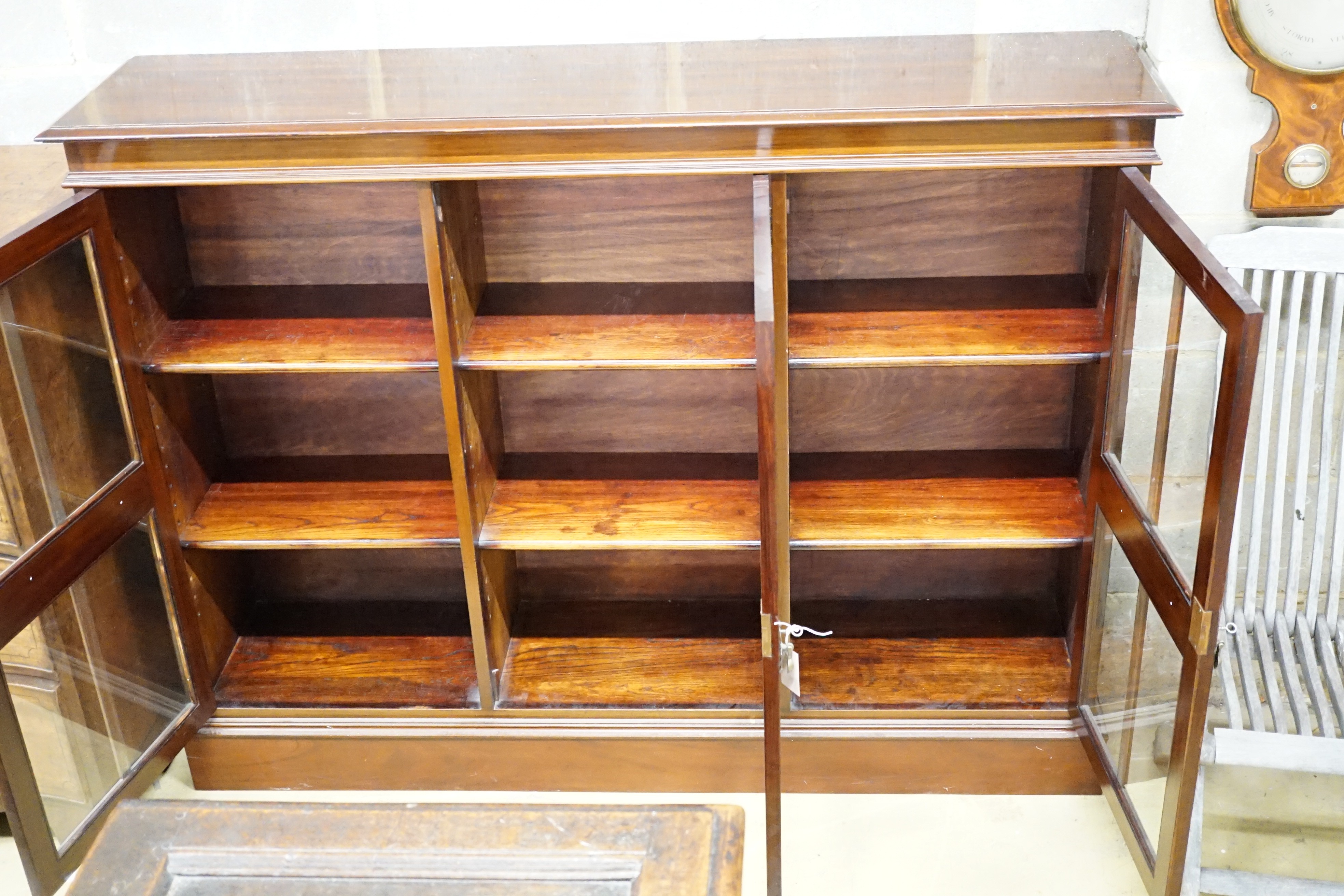 An Edwardian carved mahogany dwarf bookcase, width 153cm, height 116cm